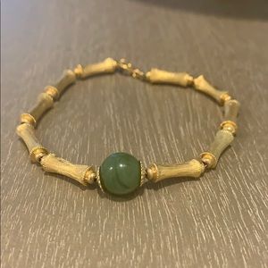 Simple gold bracelet with green stone